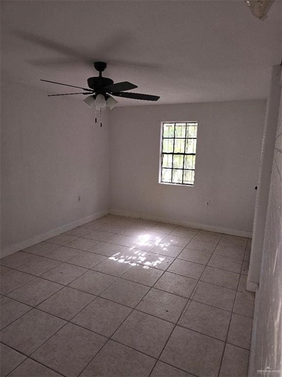 tiled empty room with ceiling fan