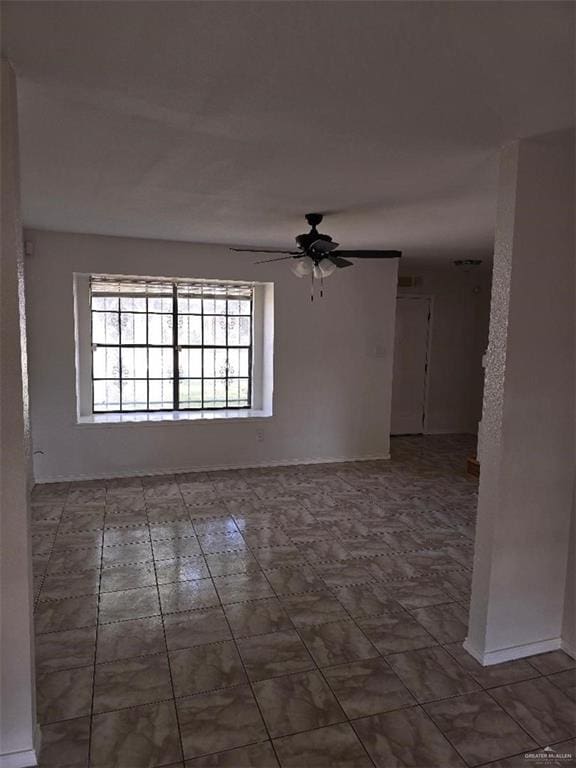 unfurnished room with ceiling fan