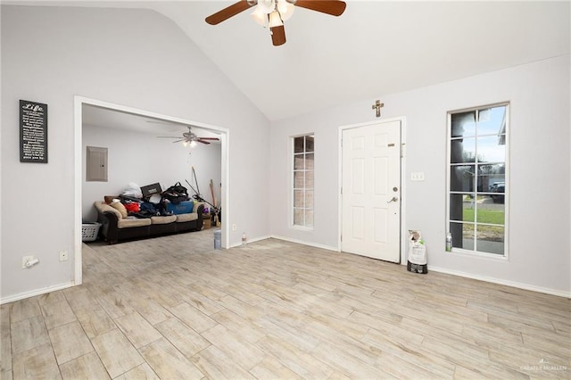 entryway with high vaulted ceiling, ceiling fan, light wood-type flooring, and electric panel