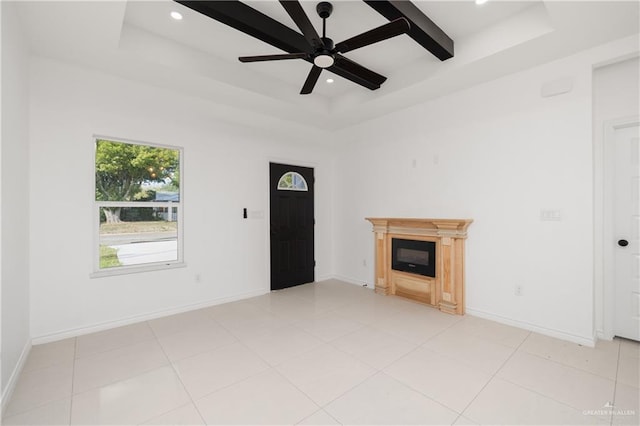 unfurnished living room featuring light tile patterned floors, a raised ceiling, and ceiling fan