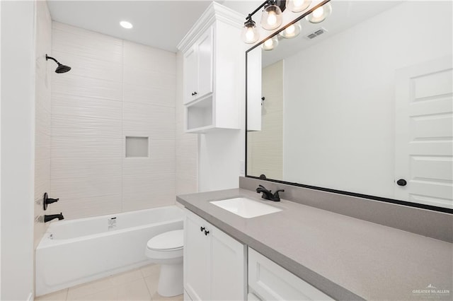 full bathroom with toilet, vanity, tiled shower / bath combo, and tile patterned floors