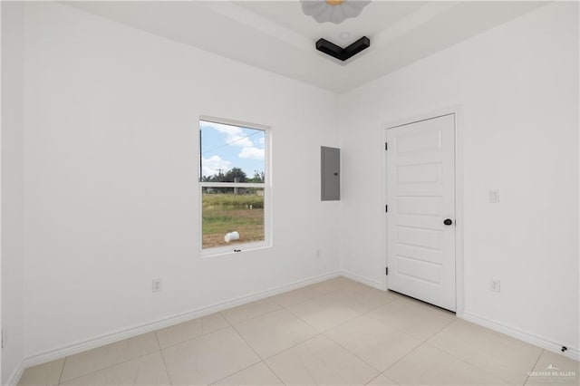 unfurnished room with light tile patterned flooring and electric panel