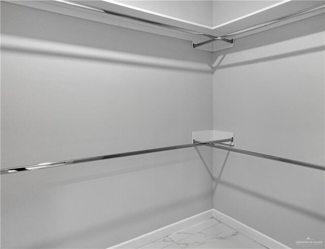 spacious closet with marble finish floor