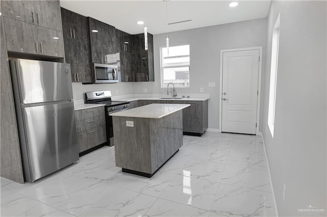 kitchen featuring a kitchen island, marble finish floor, stainless steel appliances, a sink, and recessed lighting