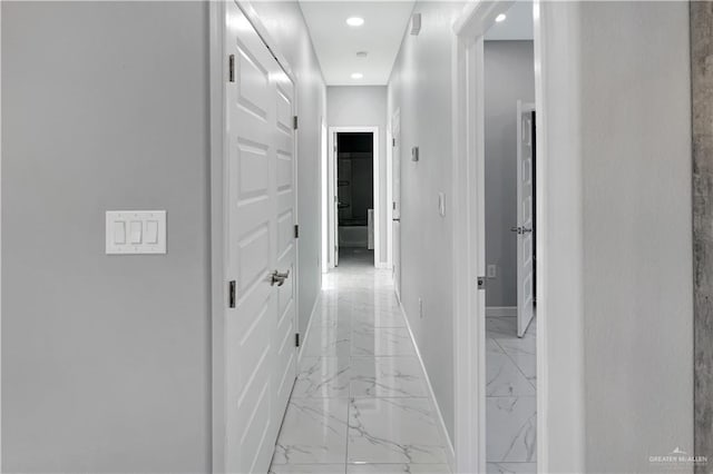 corridor featuring recessed lighting, marble finish floor, and baseboards