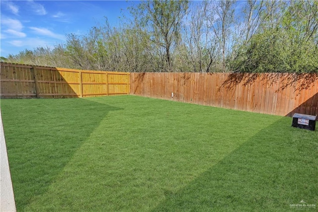 view of yard with a fenced backyard