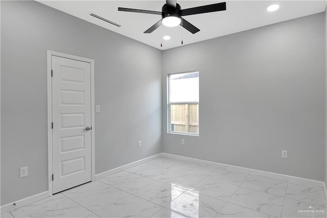 spare room with marble finish floor, recessed lighting, visible vents, a ceiling fan, and baseboards