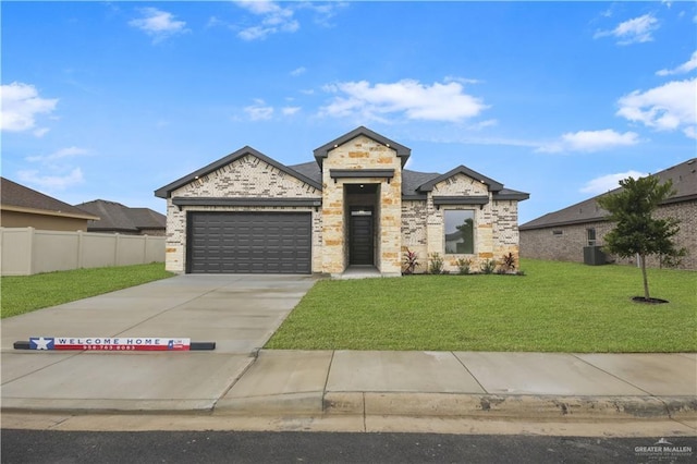 view of front of property with cooling unit, a front yard, and a garage