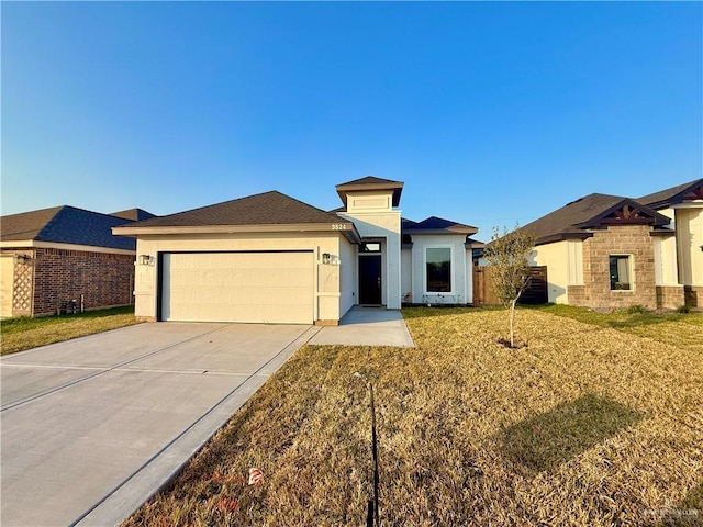 prairie-style home with a garage and a front lawn