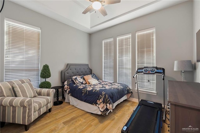 bedroom with light hardwood / wood-style floors and ceiling fan