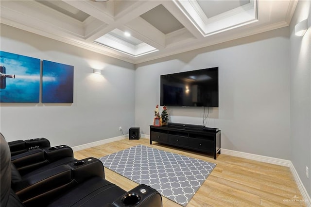 cinema room featuring beamed ceiling, ornamental molding, hardwood / wood-style flooring, and coffered ceiling