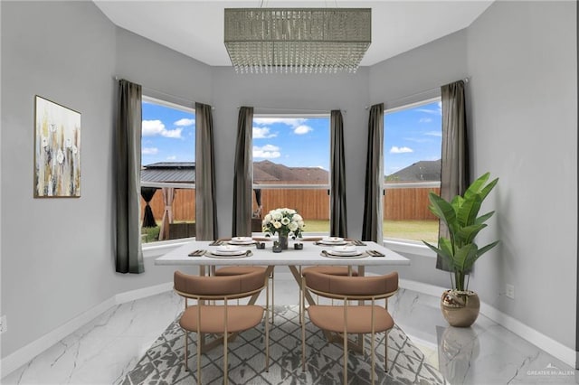 interior space featuring a mountain view, a wealth of natural light, and an inviting chandelier