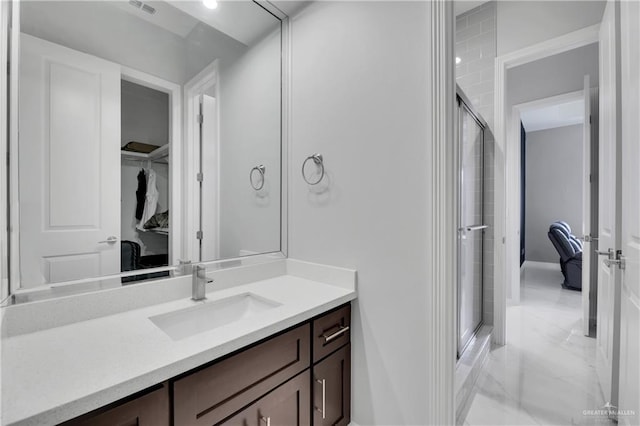 bathroom featuring vanity and an enclosed shower