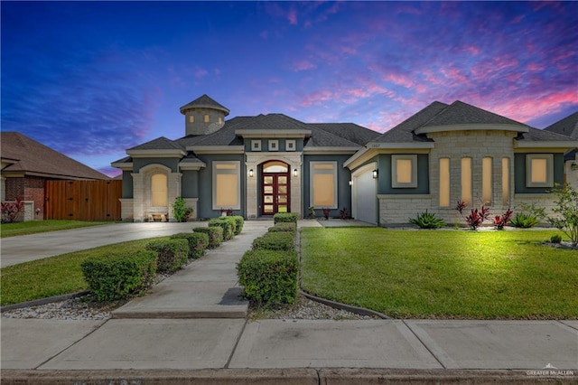 view of front of property featuring a lawn and french doors