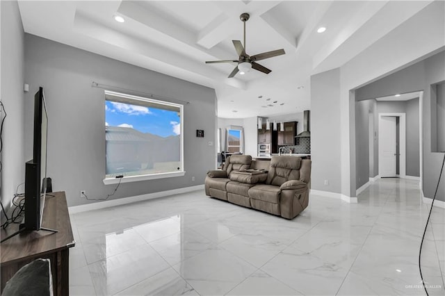 living room featuring ceiling fan and coffered ceiling