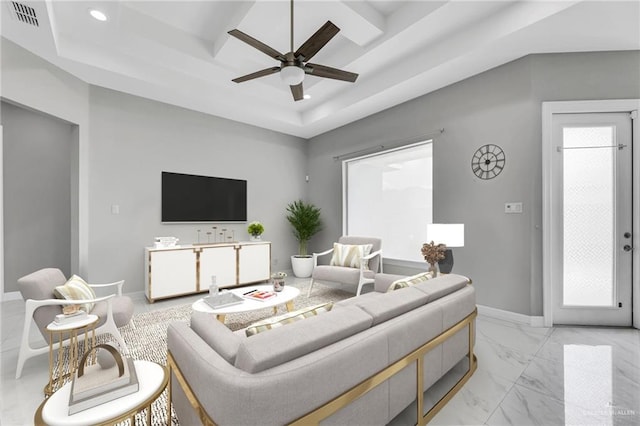 living room featuring a tray ceiling and ceiling fan