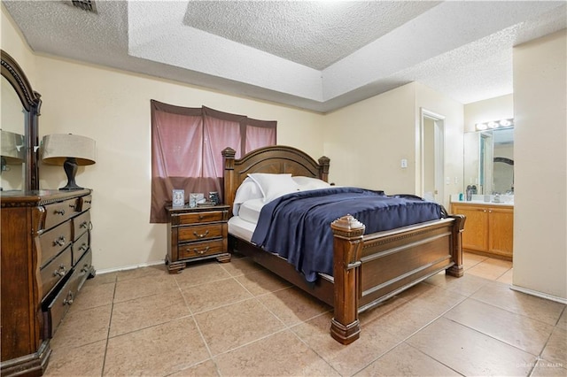 tiled bedroom with a textured ceiling and connected bathroom