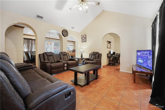 tiled living room featuring high vaulted ceiling and ceiling fan