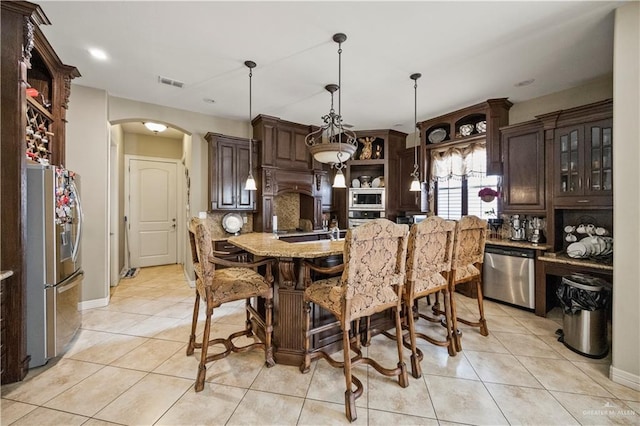 1901 Pecos St, Mission, TX 78572 - kitchen with arched walkways, stainless steel appliances, open shelves, dark brown cabinetry, and recessed lighting