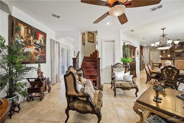 1901 Pecos St, Mission, TX 78572 - living room featuring light tile patterned floors, a ceiling fan, arched walkways, and stairway