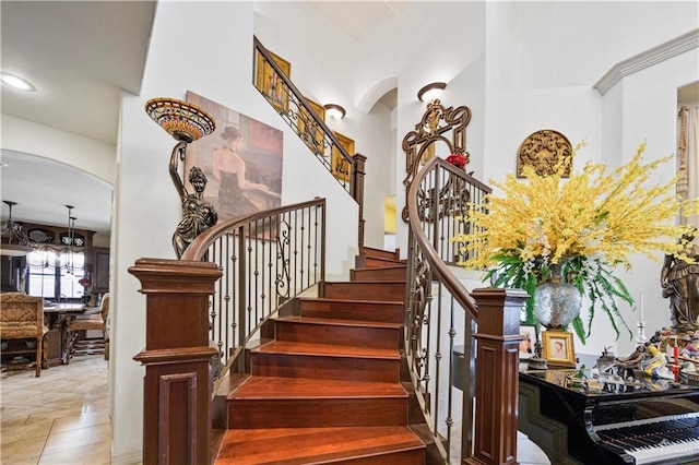 1901 Pecos St, Mission, TX 78572 - staircase with a chandelier, arched walkways, and a towering ceiling