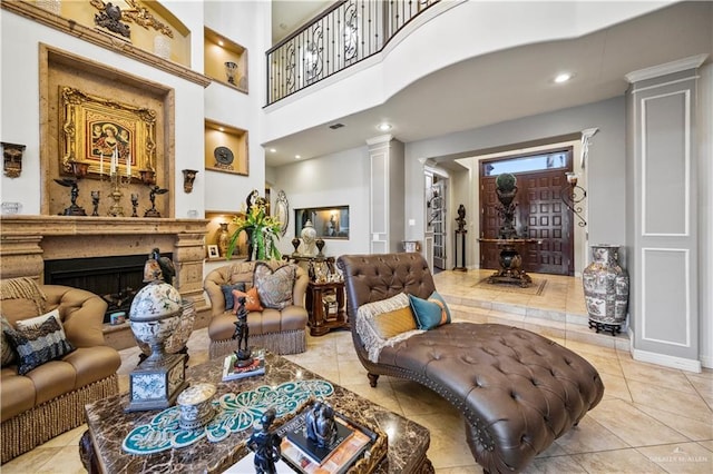 1901 Pecos St, Mission, TX 78572 - living area with decorative columns, tile patterned flooring, and a fireplace