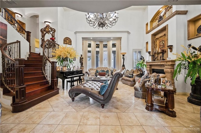 1901 Pecos St, Mission, TX 78572 - living area with stairs, a high ceiling, a chandelier, a fireplace, and tile patterned floors