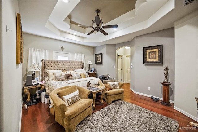 1901 Pecos St, Mission, TX 78572 - bedroom with arched walkways, a tray ceiling, wood finished floors, and ceiling fan