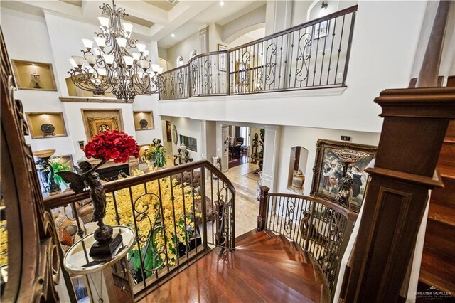 1901 Pecos St, Mission, TX 78572 - stairway with a high ceiling, a chandelier, hardwood / wood-style floors, beamed ceiling, and coffered ceiling