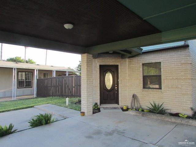 view of exterior entry with a patio area