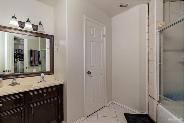 bathroom featuring vanity, tile patterned floors, and bath / shower combo with glass door