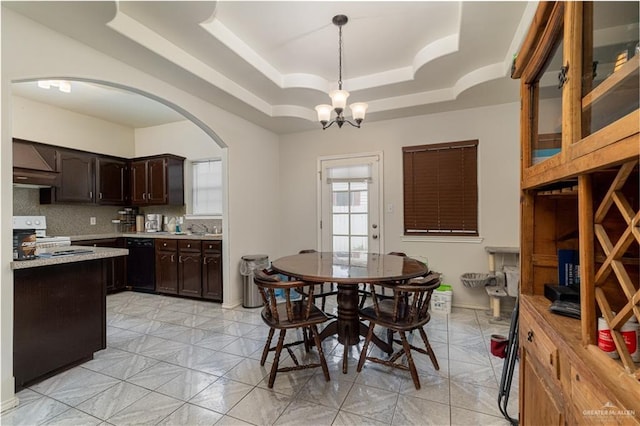 dining room with a chandelier and a tray ceiling