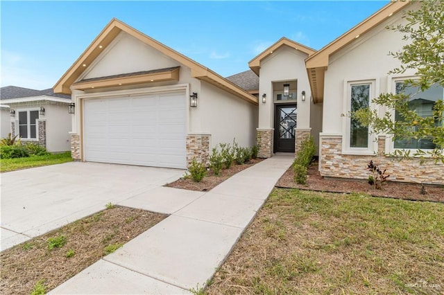 view of front of property with an attached garage, stone siding, driveway, and stucco siding