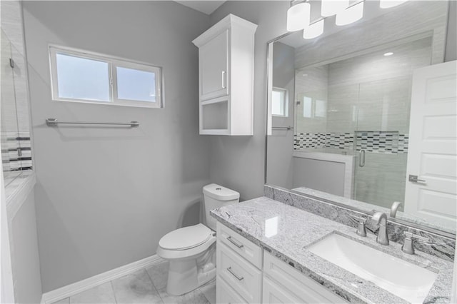 bathroom featuring toilet, a shower stall, baseboards, and vanity