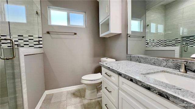 bathroom featuring tile patterned floors, vanity, toilet, and a shower with door