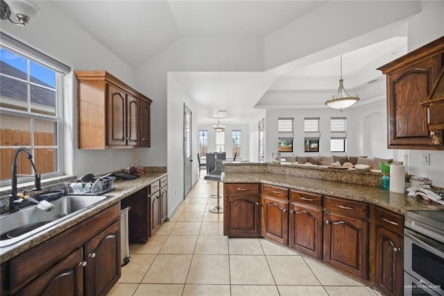 604 Hackberry Ave, Mission, TX 78572 - kitchen with a sink, healthy amount of natural light, stainless steel range with electric stovetop, pendant lighting, and lofted ceiling