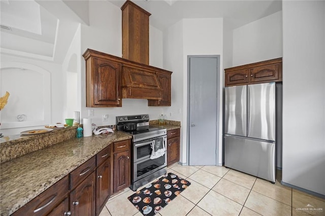 604 Hackberry Ave, Mission, TX 78572 - kitchen with stainless steel appliances, stone counters, and light tile patterned floors
