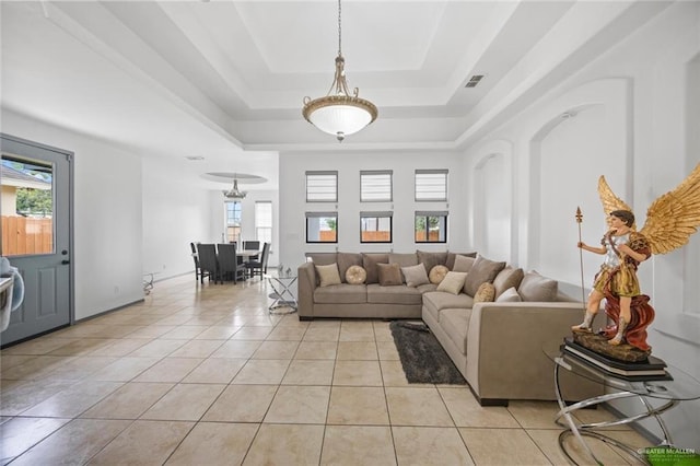 604 Hackberry Ave, Mission, TX 78572 - living area featuring a tray ceiling, healthy amount of natural light, and light tile patterned floors