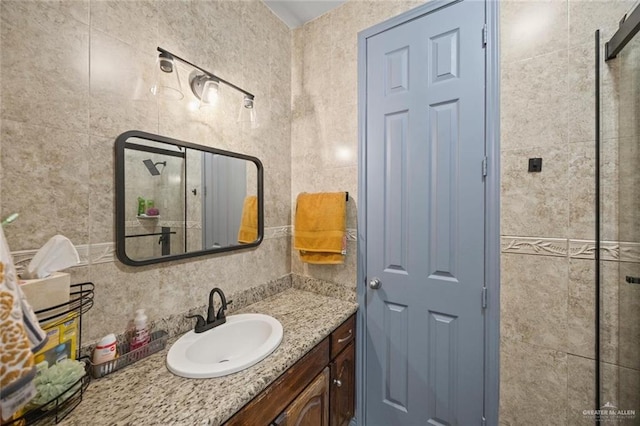 604 Hackberry Ave, Mission, TX 78572 - bathroom with vanity, tasteful backsplash, and tile walls