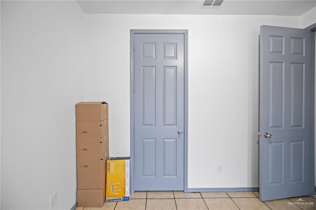 604 Hackberry Ave, Mission, TX 78572 - unfurnished bedroom with light tile patterned flooring and baseboards