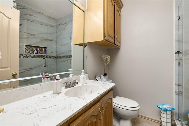 bathroom featuring walk in shower, vanity, toilet, and tile patterned flooring