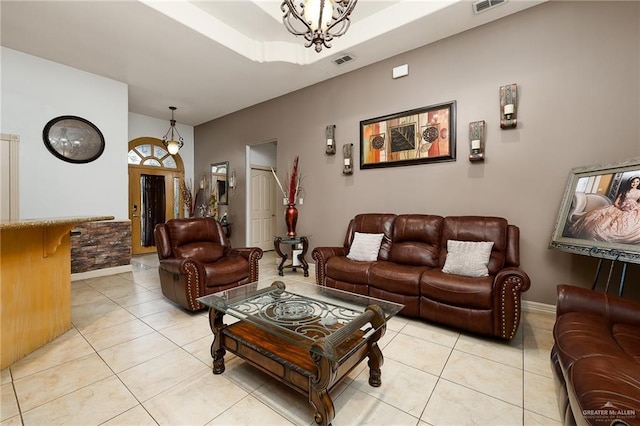 tiled living room featuring a chandelier