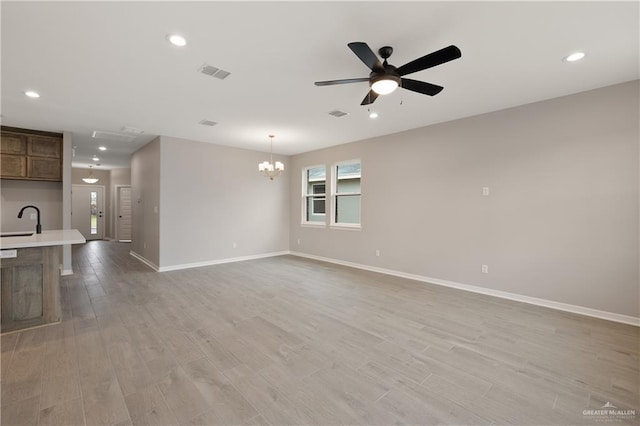 8329 N 35th St, Mcallen, TX 78504 - unfurnished living room with ceiling fan, light wood finished floors, a chandelier, and recessed lighting