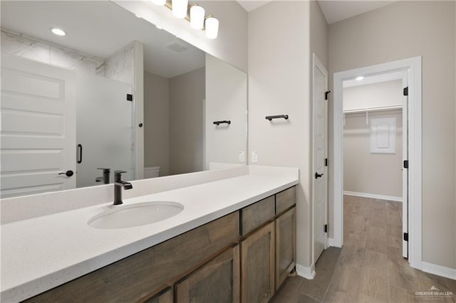8329 N 35th St, Mcallen, TX 78504 - full bath featuring vanity, a walk in closet, wood finished floors, a shower, and recessed lighting