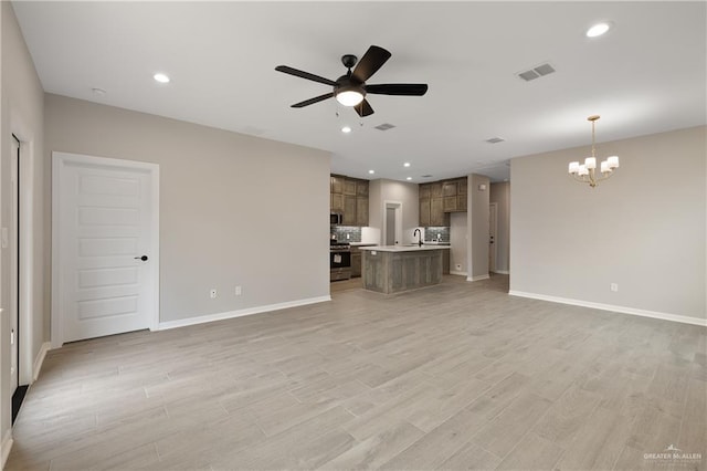 8329 N 35th St, Mcallen, TX 78504 - unfurnished living room with a ceiling fan, a chandelier, light wood-type flooring, and recessed lighting