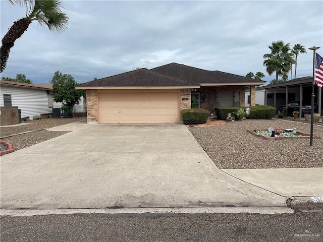 view of front of home with a garage and central AC unit