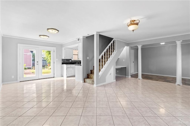 interior space featuring ornamental molding, decorative columns, french doors, and light tile patterned flooring