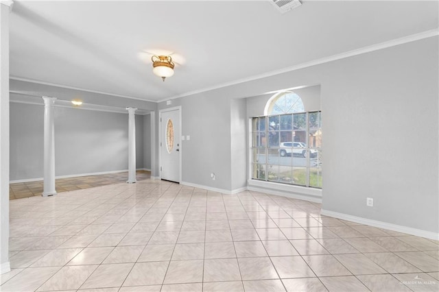 tiled spare room with decorative columns and ornamental molding