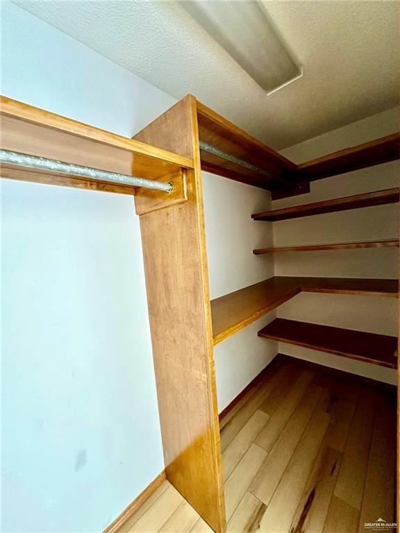 spacious closet featuring hardwood / wood-style floors