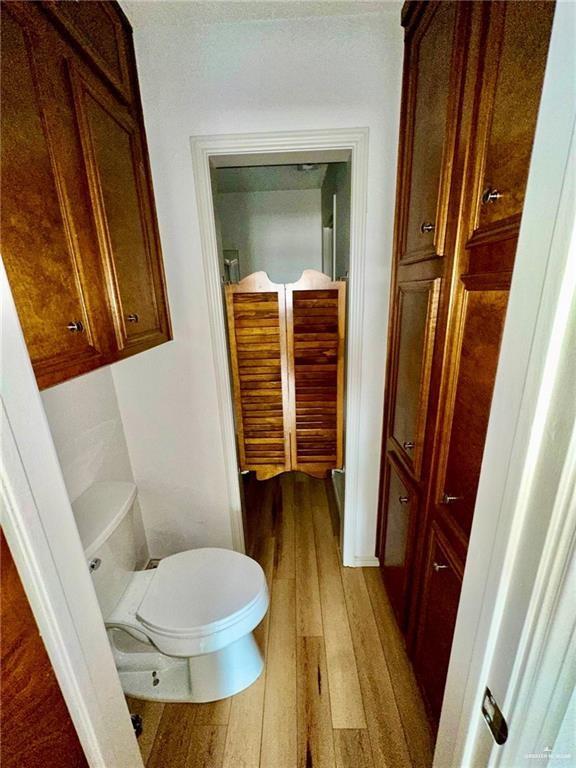 bathroom featuring hardwood / wood-style floors and toilet